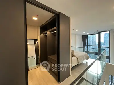 Modern loft apartment with walk-in closet and city view, featuring sleek design and spacious layout.