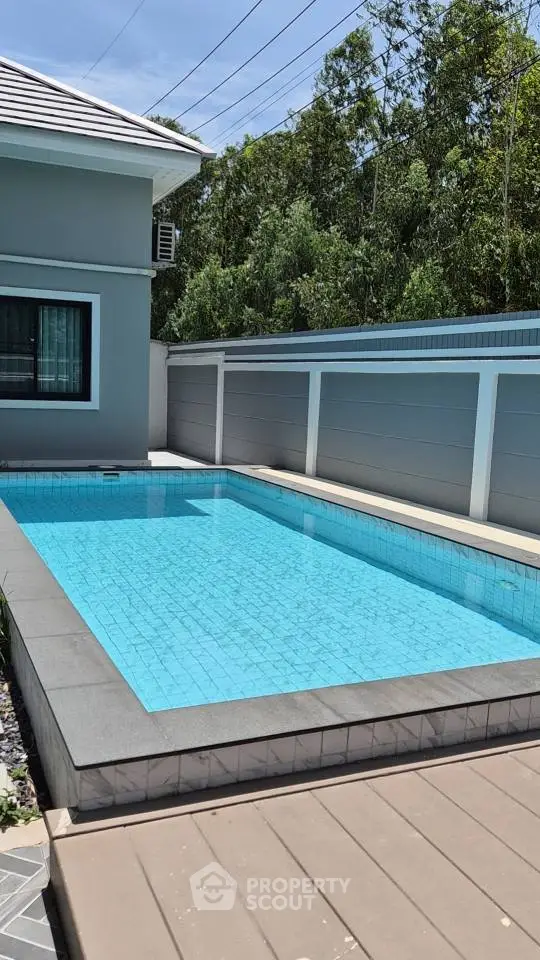 Luxurious private pool in modern residential backyard with sleek design and serene surroundings.