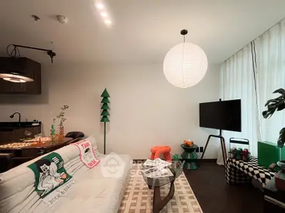 Stylish living room with modern decor and cozy seating area, perfect for relaxation and entertainment.