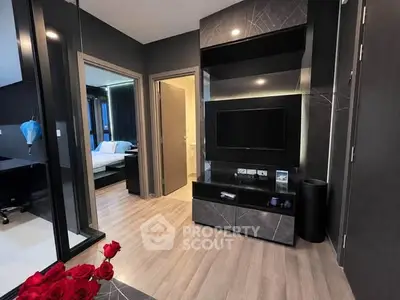 Modern living room with sleek design and open view to bedroom and bathroom
