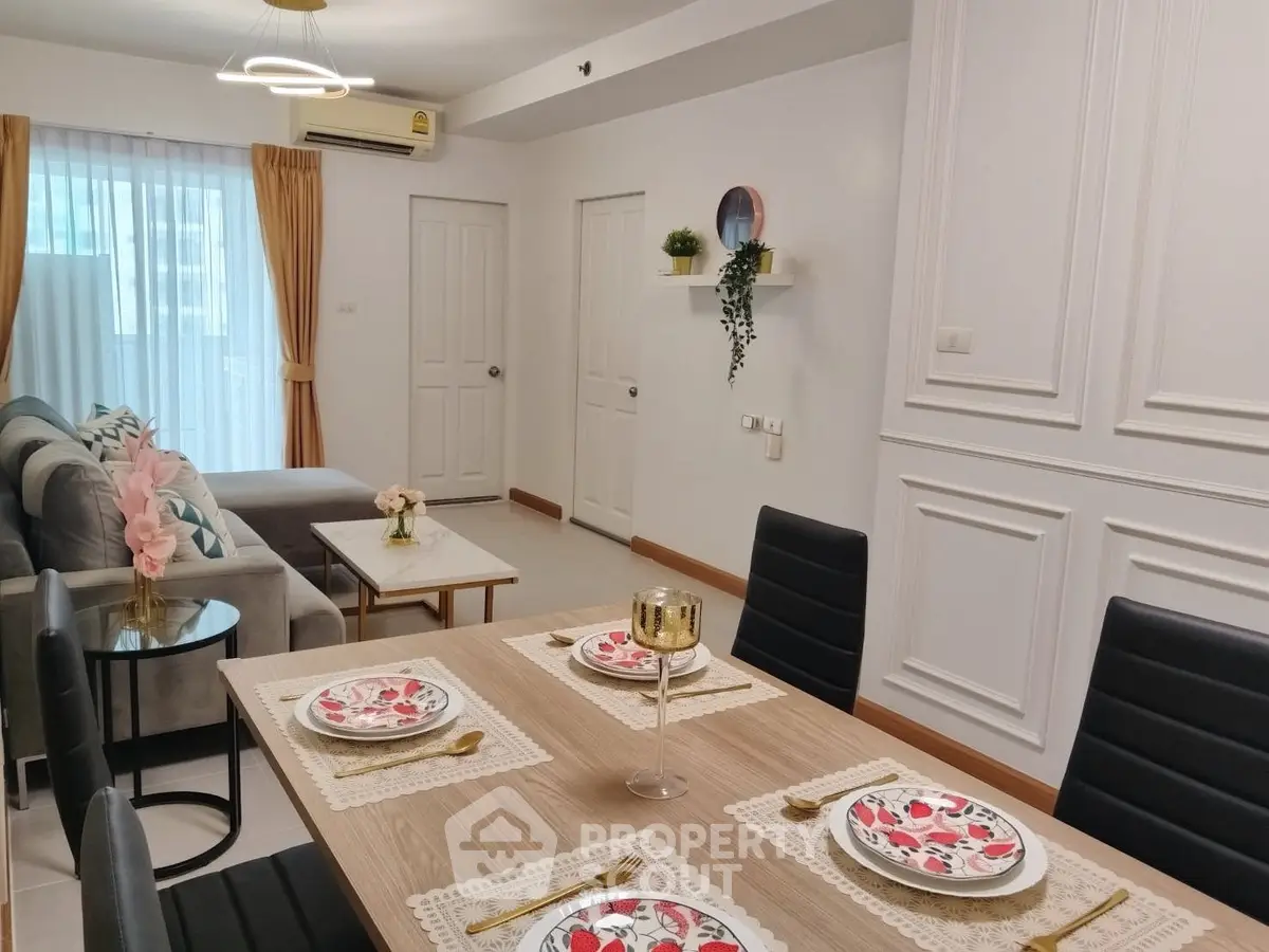 Stylish living room with elegant dining area and modern decor in a contemporary apartment.