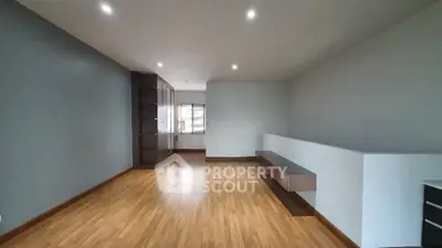Spacious modern living room with wooden flooring and sleek design