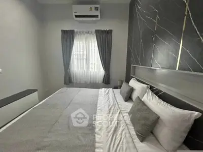 Modern bedroom with stylish decor and natural light, featuring a comfortable bed and elegant curtains.