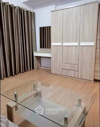 Modern bedroom with wooden wardrobe and glass coffee table