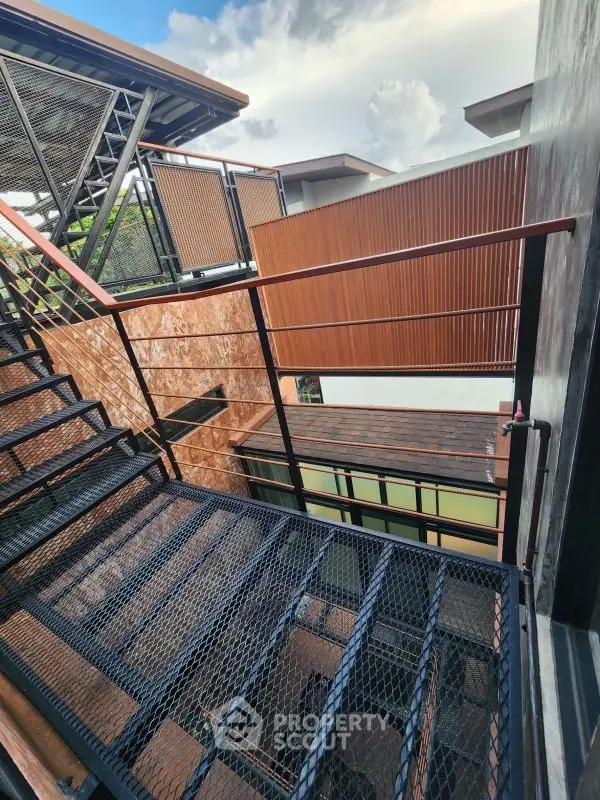 Modern exterior staircase with sleek metal design and wooden accents