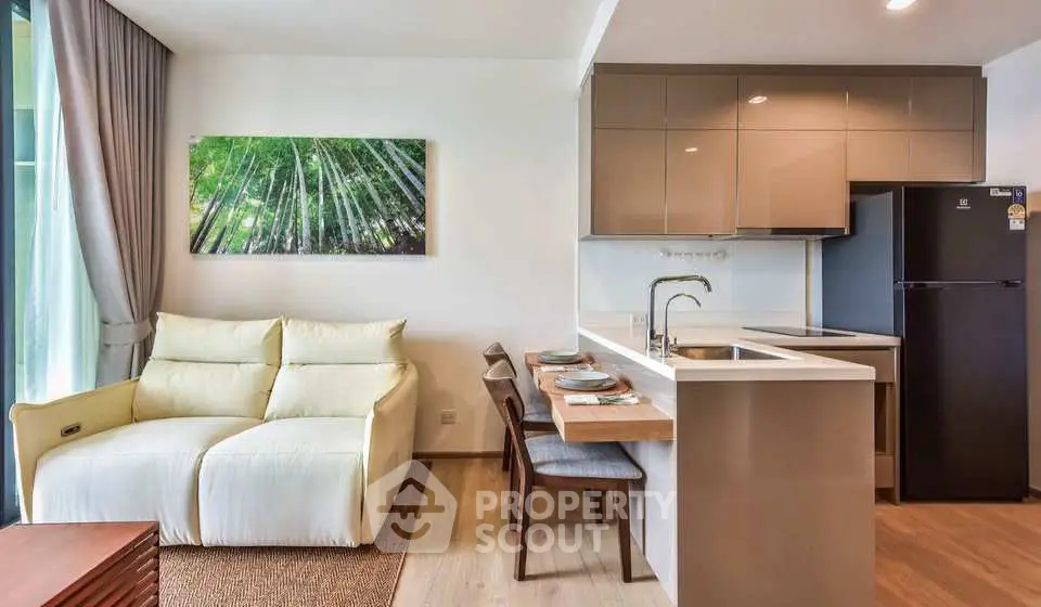 Modern open-plan living room and kitchen with sleek design and natural light.