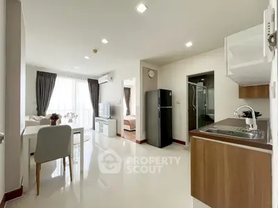 Modern open-plan apartment with sleek kitchen and bright living area