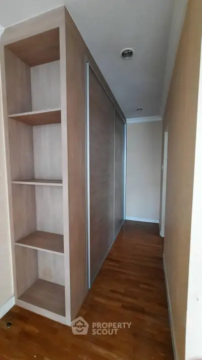 Spacious hallway with built-in wooden storage and sleek sliding doors