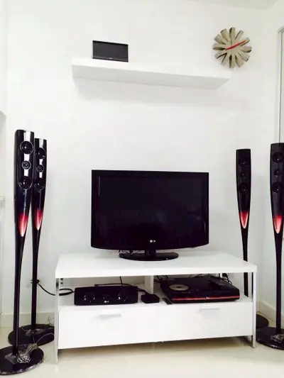 Modern living room with sleek entertainment setup and stylish speakers