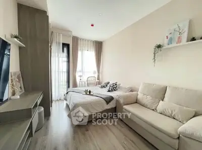 Modern bedroom with cozy sofa and stylish decor in bright apartment