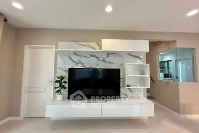 Modern living room with sleek TV unit and marble accent wall, perfect for stylish home entertainment.