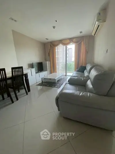 Spacious living room with elegant furniture and large windows for natural light.