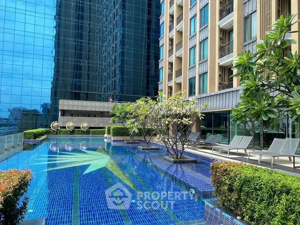 Luxurious apartment building with stunning outdoor pool and modern architecture.