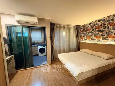 Modern bedroom with stylish decor and adjacent laundry area