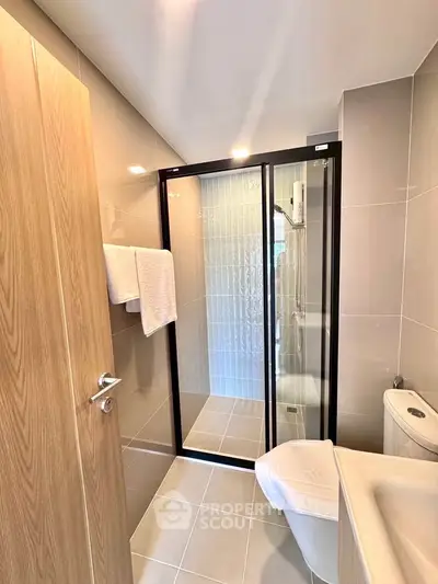 Modern bathroom with sleek shower enclosure and contemporary fixtures