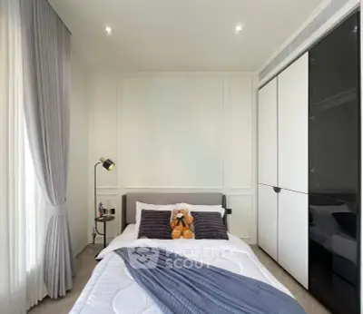 Cozy modern bedroom with stylish decor and ample storage space