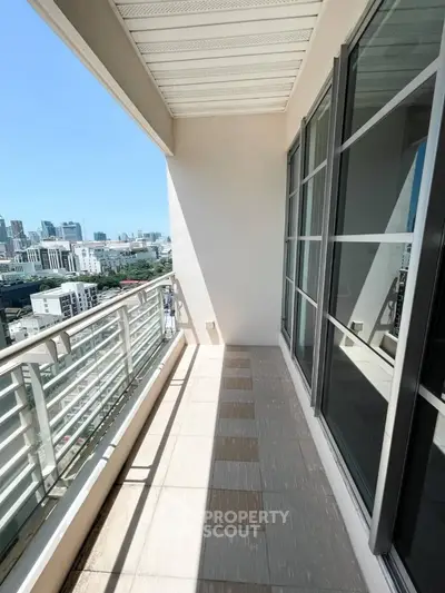 Spacious balcony with stunning city view in modern high-rise apartment