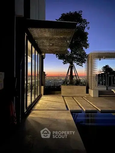 Stunning modern balcony with panoramic city view at sunset, featuring sleek architecture and serene ambiance.