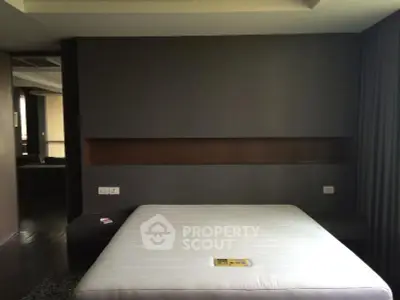 Modern minimalist bedroom with sleek design and neutral tones, featuring a built-in wall shelf.