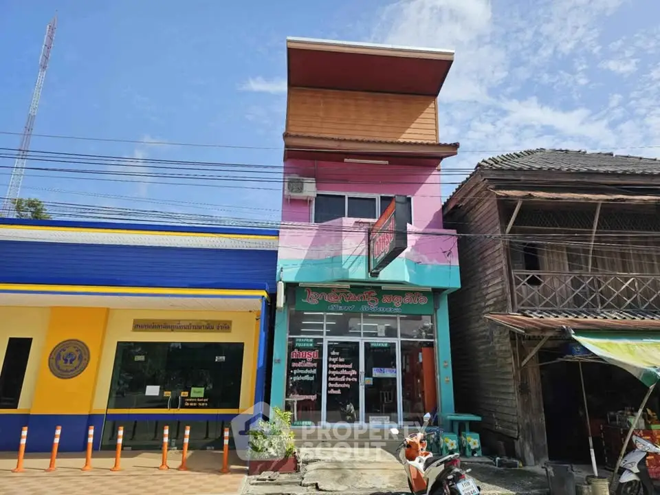 Charming colorful commercial building with unique facade and street view