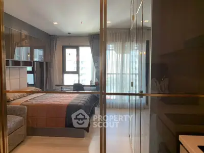 Modern bedroom with glass partition and stylish decor in urban apartment