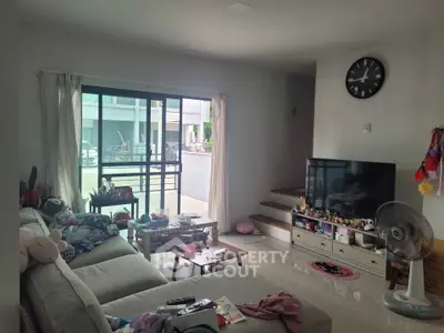 Cozy living room with modern decor and large sliding glass doors leading to a balcony.