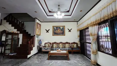 Elegant living room with classic wooden furniture and chandelier