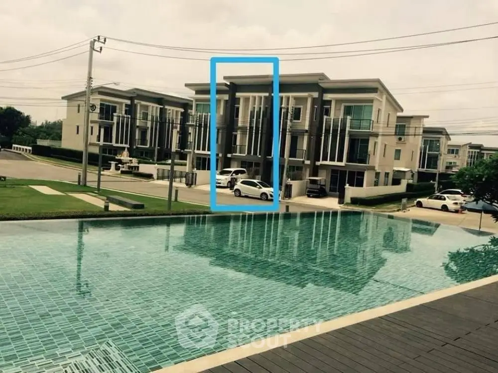 Modern residential complex with pool view and contemporary architecture.