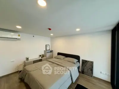Modern bedroom with cozy bed and minimalist decor in a stylish apartment.
