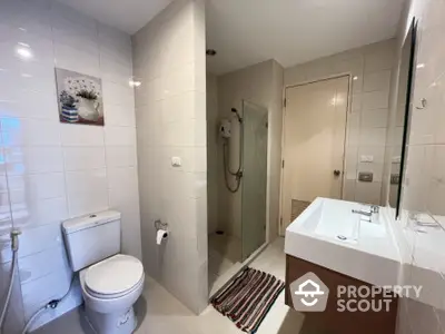 Modern bathroom with sleek fixtures and spacious shower area.