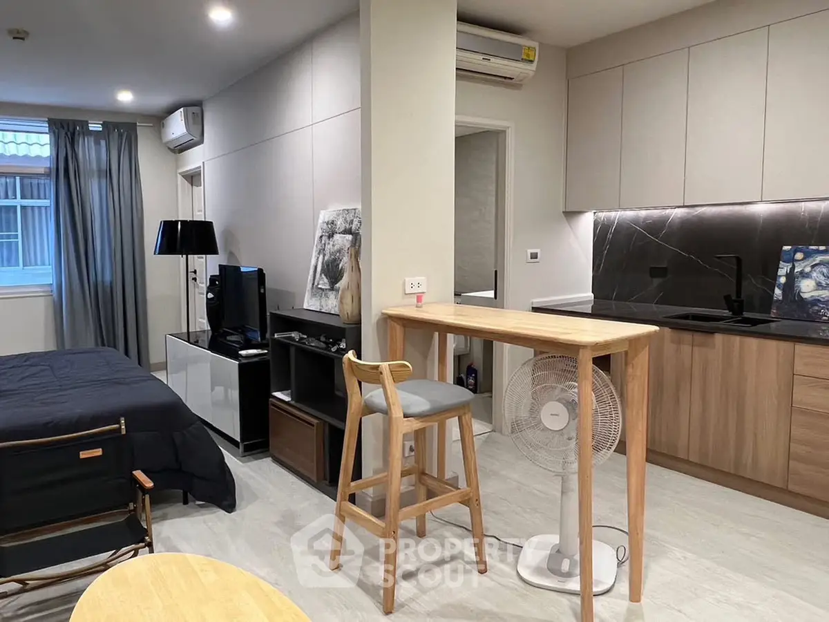 Modern studio apartment with open kitchen and stylish decor