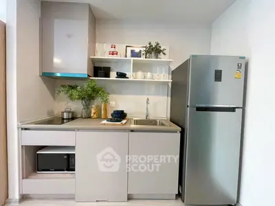 Modern kitchen with sleek cabinetry and stainless steel fridge