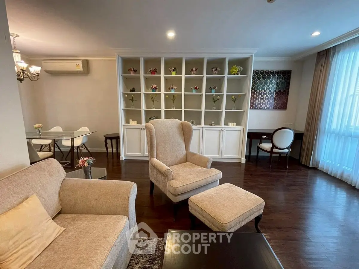 Elegant living room with cozy seating and stylish decor in a modern apartment.