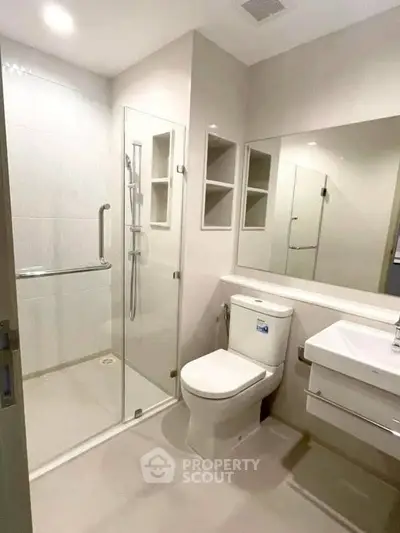 Modern bathroom with glass shower and sleek fixtures