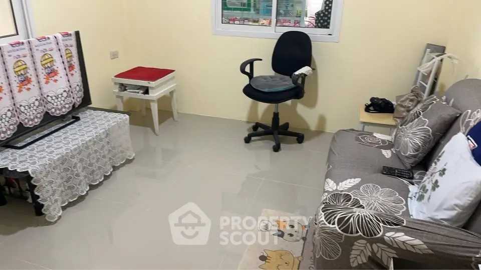 Cozy living room with sofa, chair, and TV stand in a compact space.