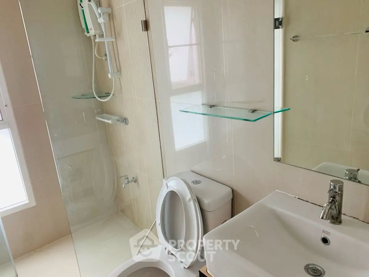Modern bathroom with glass shower and sleek fixtures