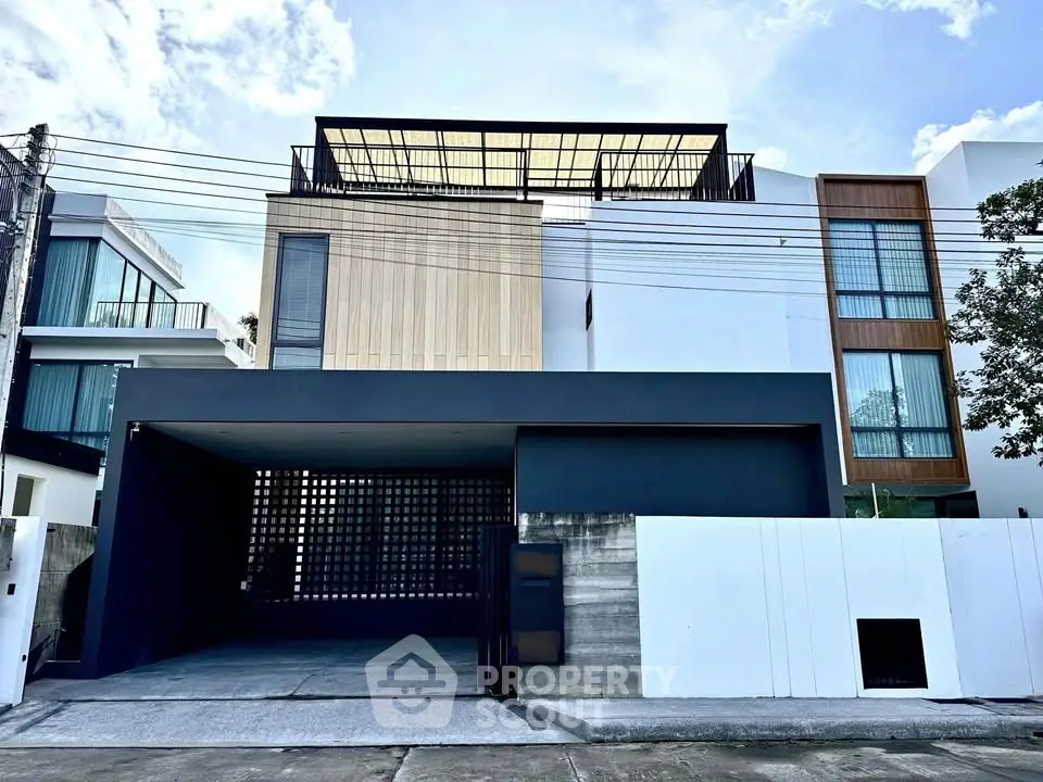 Modern architectural home with sleek facade and spacious garage in urban setting.