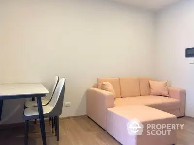 Cozy modern living room with peach sofa and dining table, perfect for small apartments.