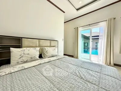 Spacious bedroom with pool view and elegant decor