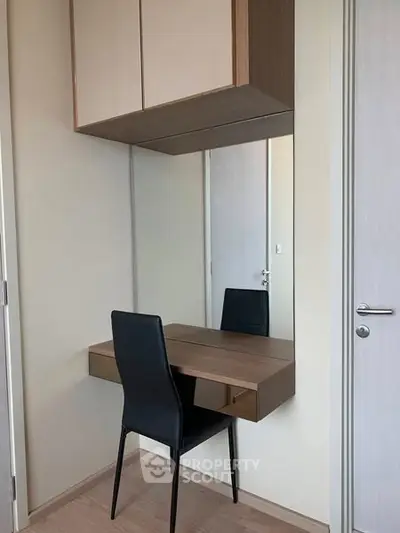Modern study nook with sleek chair and wall-mounted desk in minimalist design.