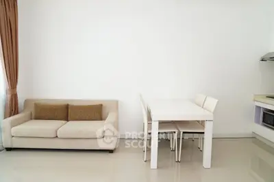 Modern minimalist living room with beige sofa and white dining set, perfect for cozy gatherings.