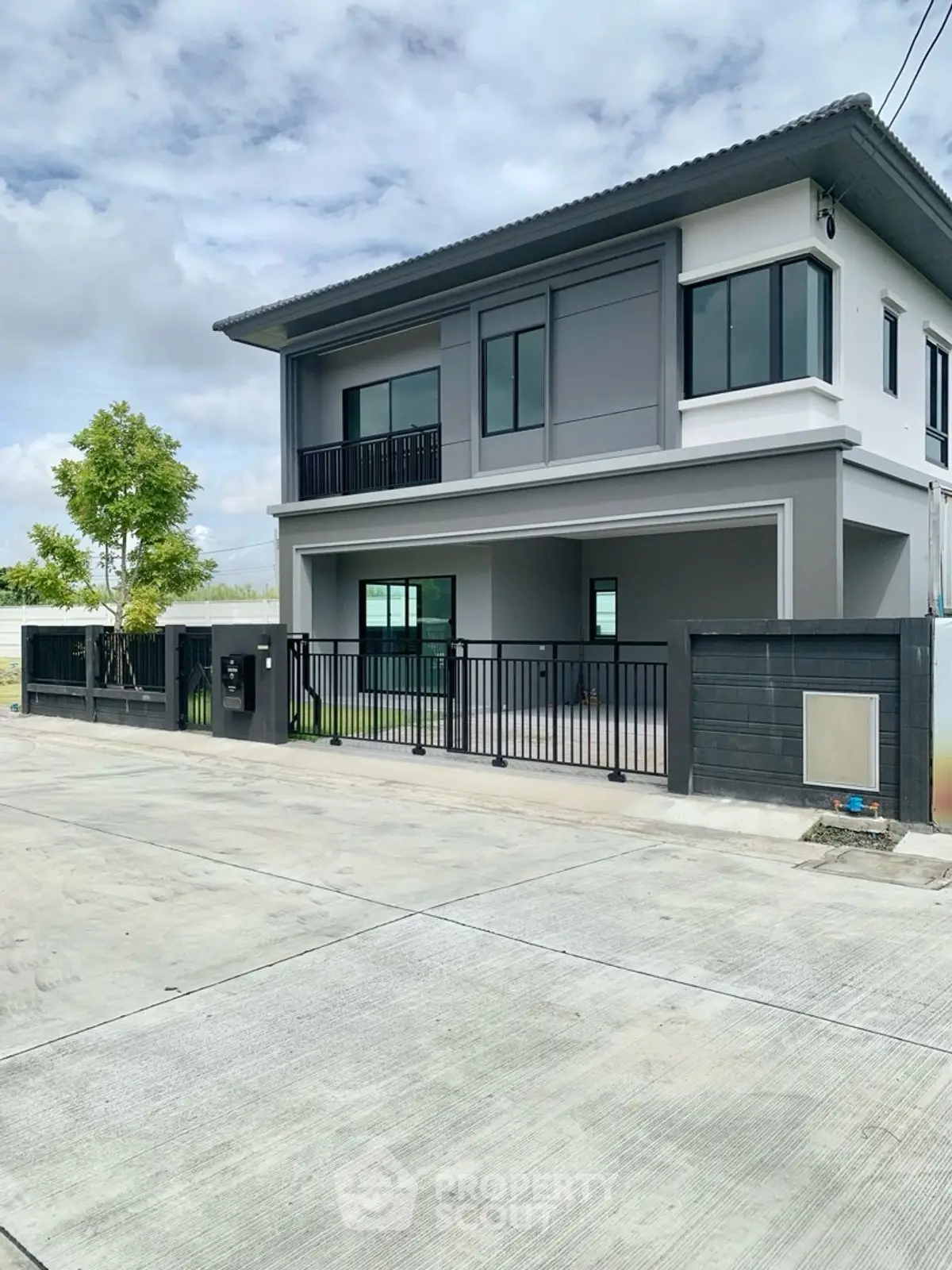 Modern two-story house with sleek design and spacious driveway