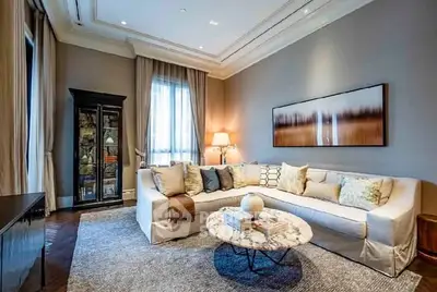 Elegant living room with plush sofa, stylish decor, and ambient lighting.