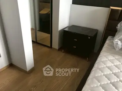 Modern bedroom with wooden flooring and mirrored closet doors