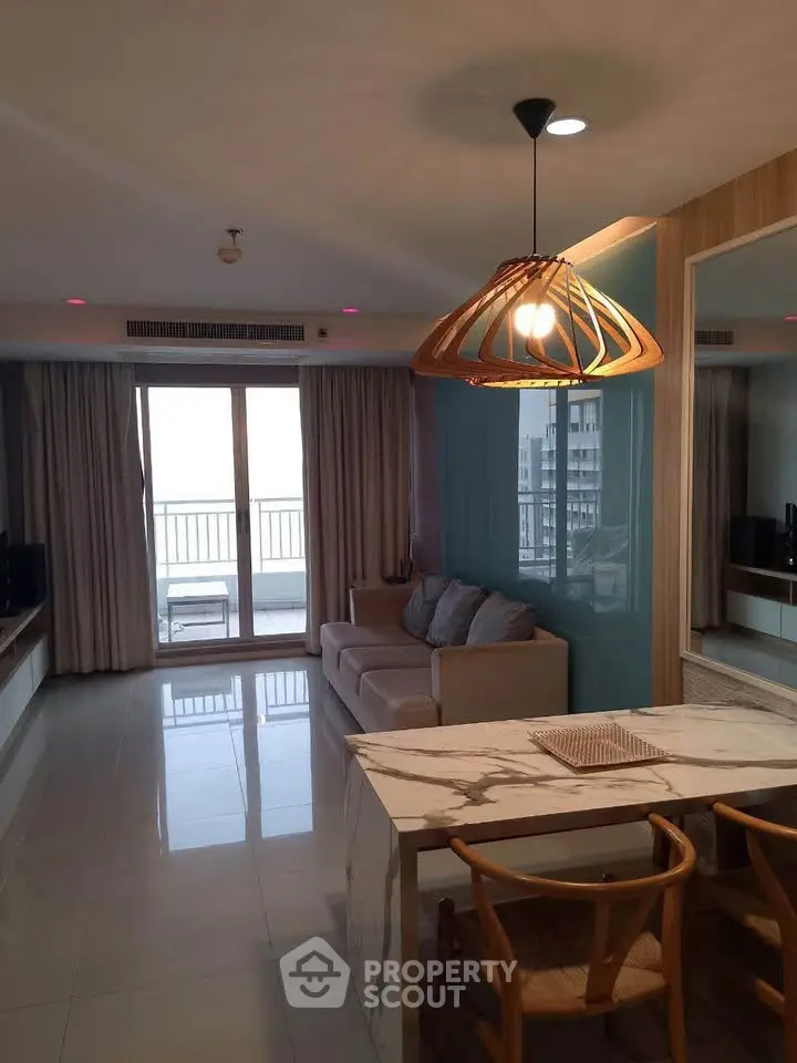 Modern living room with stylish lighting and balcony view
