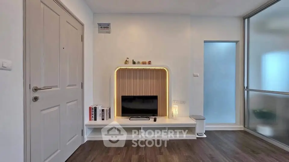 Modern living room with stylish TV unit and wooden flooring