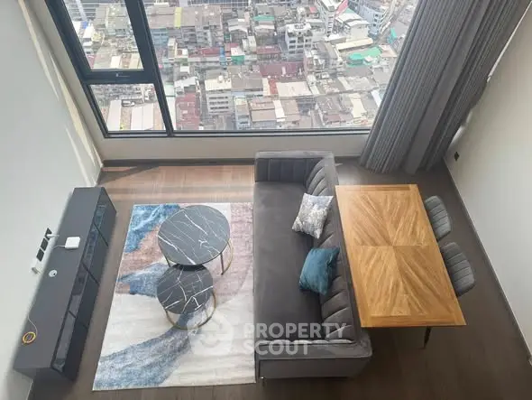 Stunning high-rise living room with panoramic city view, modern furniture, and elegant decor.