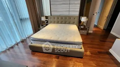 Luxurious bedroom with elegant decor and hardwood flooring