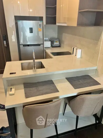 Modern kitchen with sleek countertops and built-in appliances in a stylish apartment.