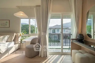 Bright and airy living room with large windows and balcony view in modern home.